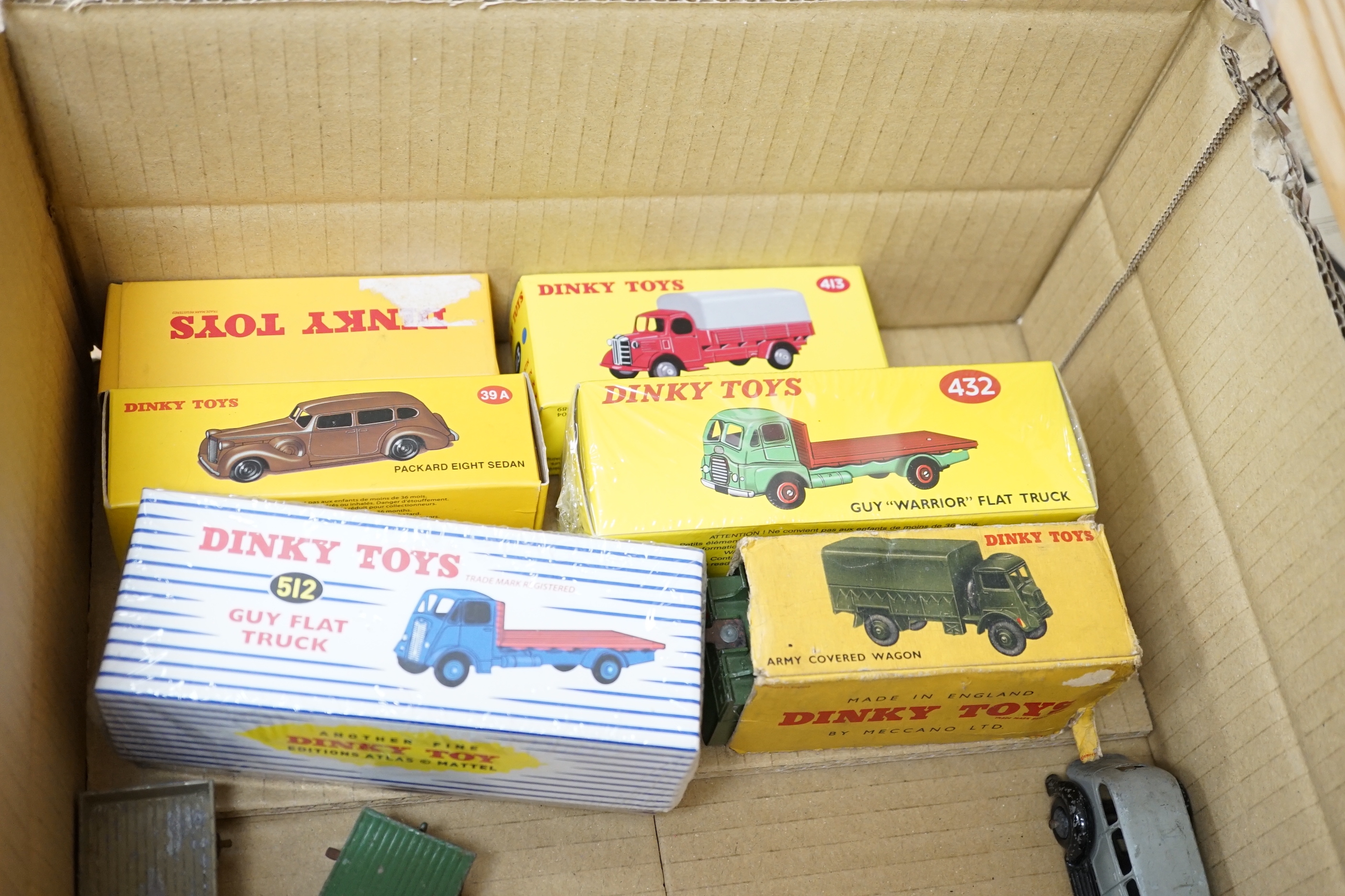 Twenty-five Dinky Toys and Atlas Dinky including a few pre-war examples; Delivery lorries, Market Gardener’s wagon, a Streamlined Fire Engine, a Jaguar SS, Mechanical Horse, etc. together with five Atlas stinky, includin